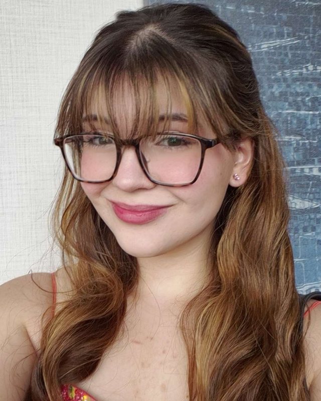 Holly, the designer behind The Blank Canvas Web, smiling in glasses